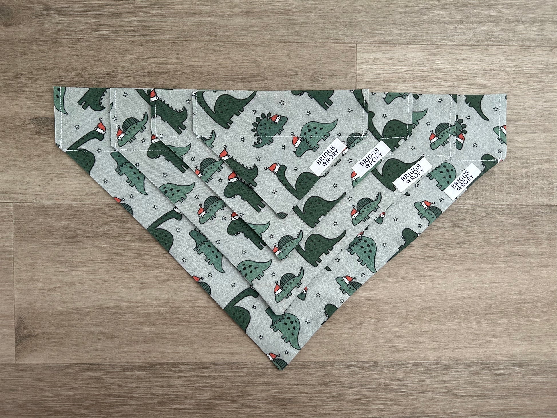 Christmas Dinosaur Dog Bandana made by Briggs and Rory, available in 4 different sizes